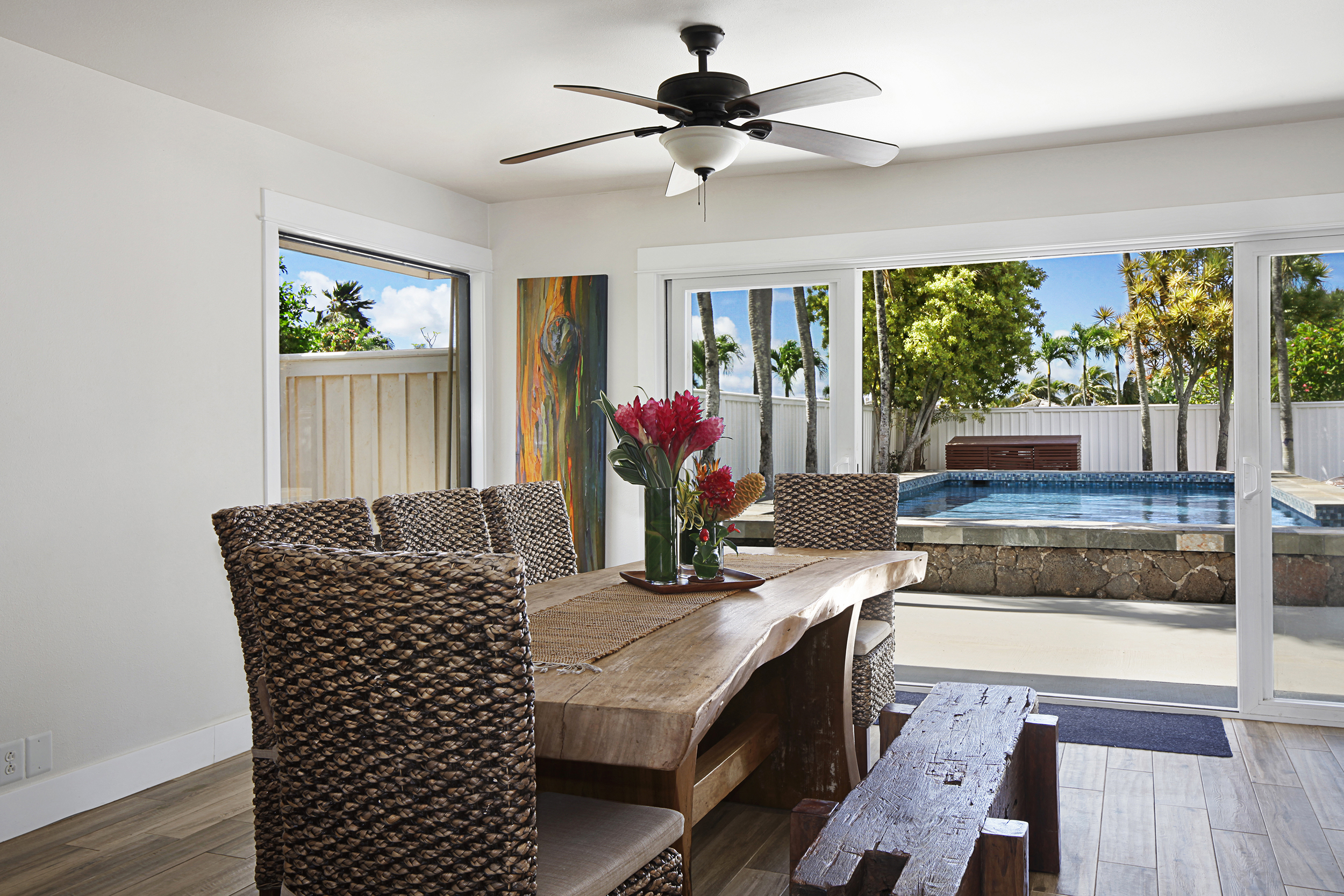 2750 Milo Hae Loop Koloa, HI 96756 - Photo 4 of 23 a kitchen with granite countertop a stove a sink a dining table and chairs with wooden floor