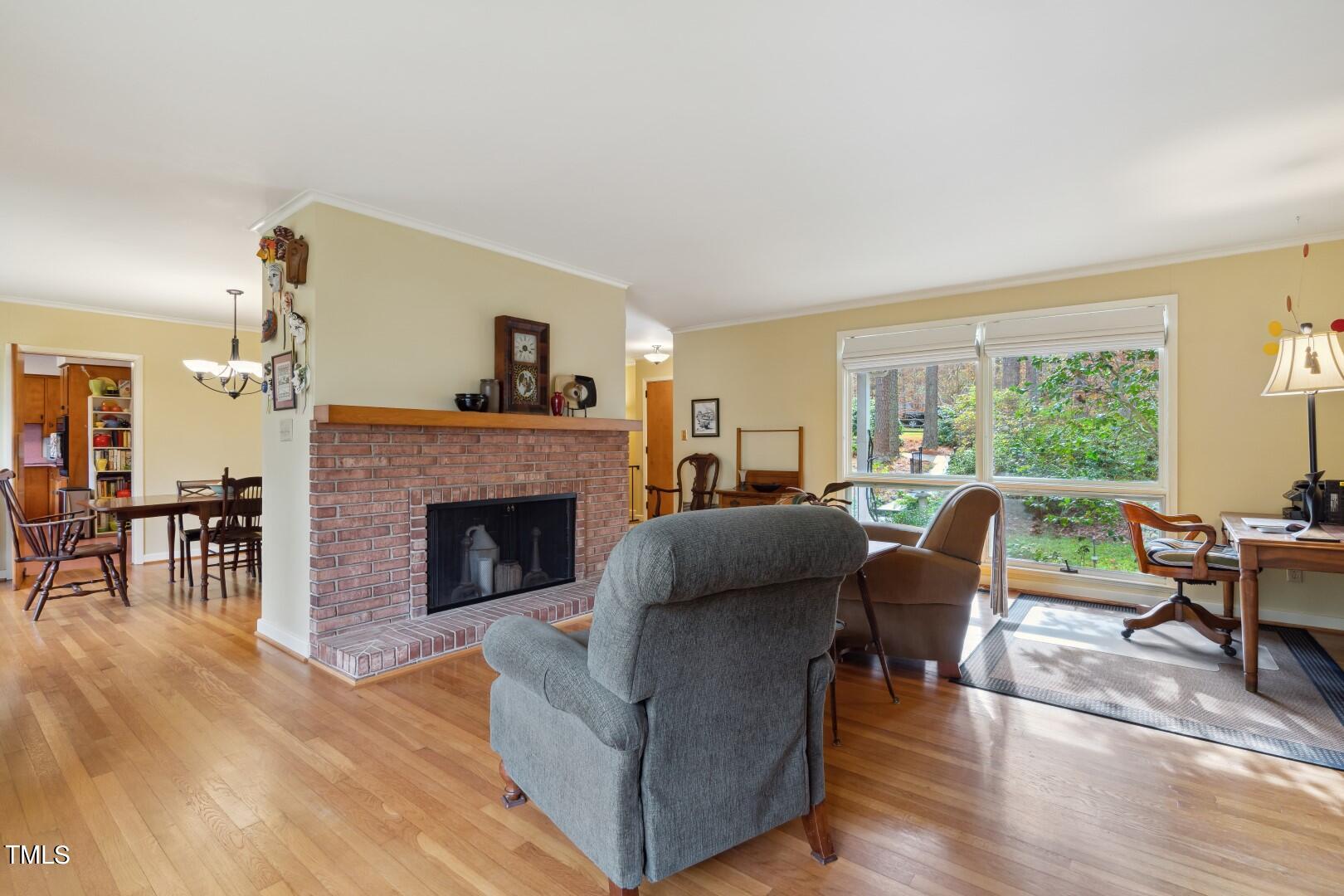 3120 Tanager Street Raleigh, NC 27606 - Photo 11 of 70 a living room with furniture and a fireplace