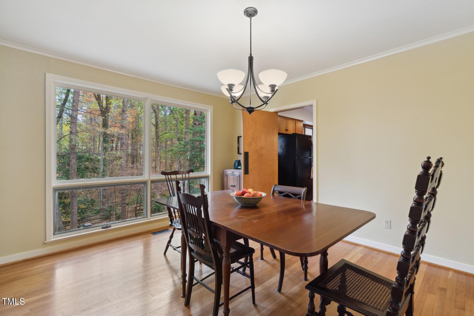 3120 Tanager Street Raleigh, NC 27606 - Photo 14 of 70 a view of a dining room with furniture window and outside view