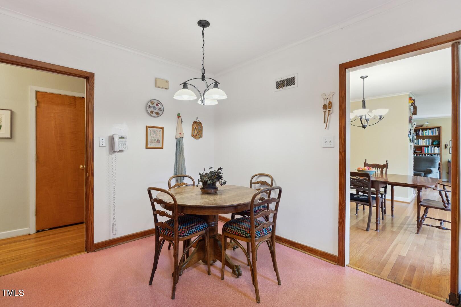 3120 Tanager Street Raleigh, NC 27606 - Photo 16 of 70 a view of a dining room with furniture and wooden floor