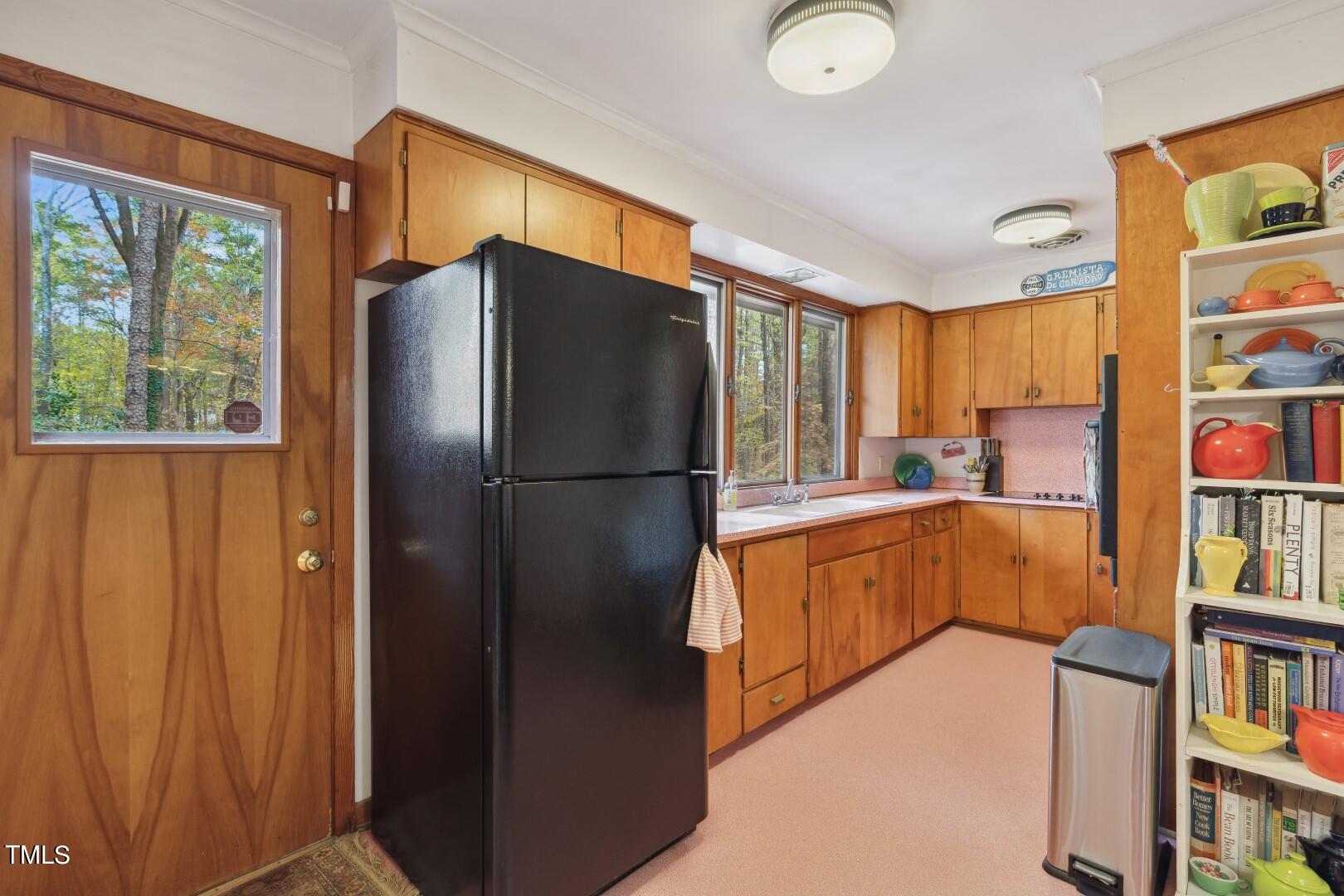3120 Tanager Street Raleigh, NC 27606 - Photo 21 of 70 a kitchen with stainless steel appliances granite countertop a refrigerator and a sink