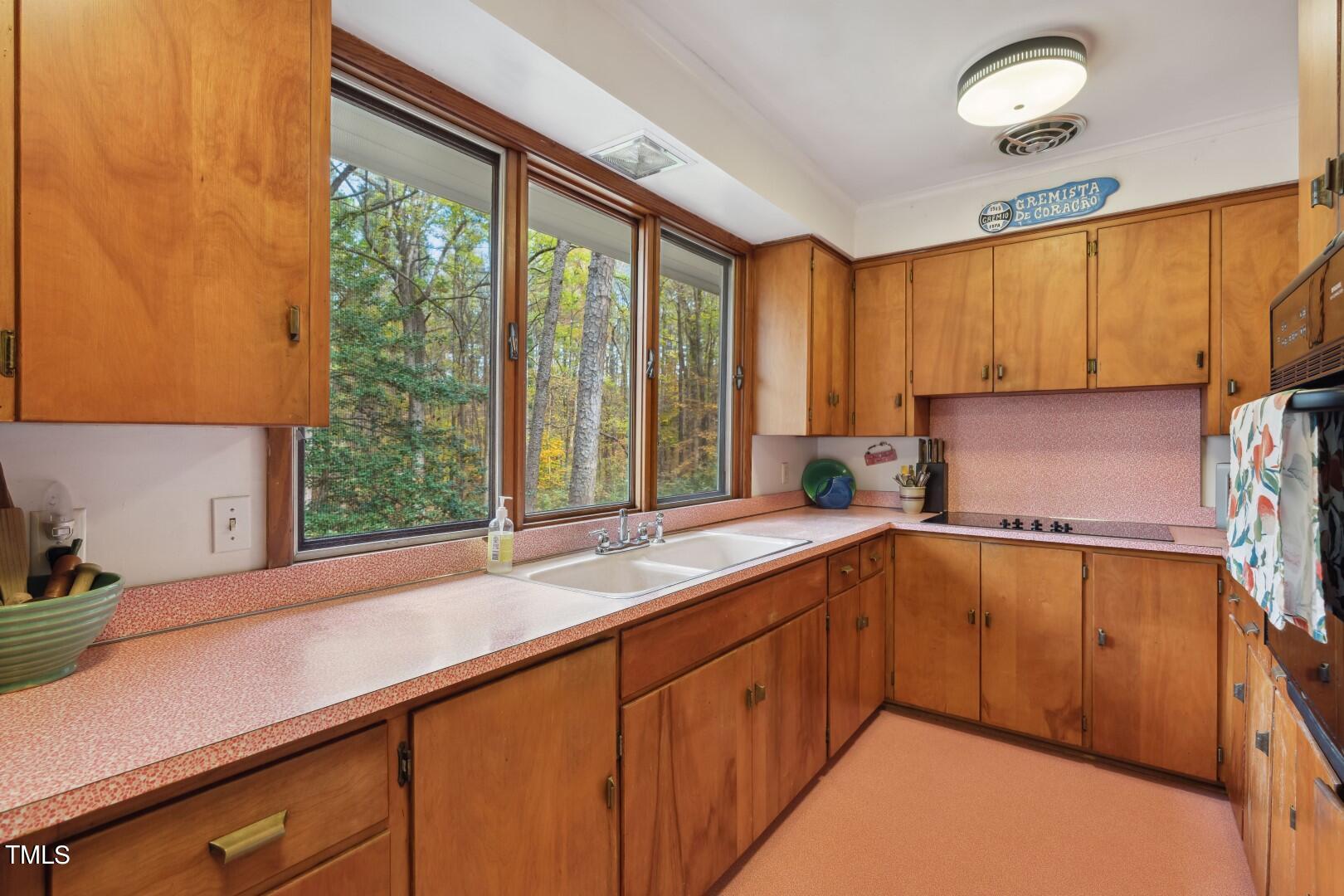 3120 Tanager Street Raleigh, NC 27606 - Photo 23 of 70 a kitchen with a sink and a window