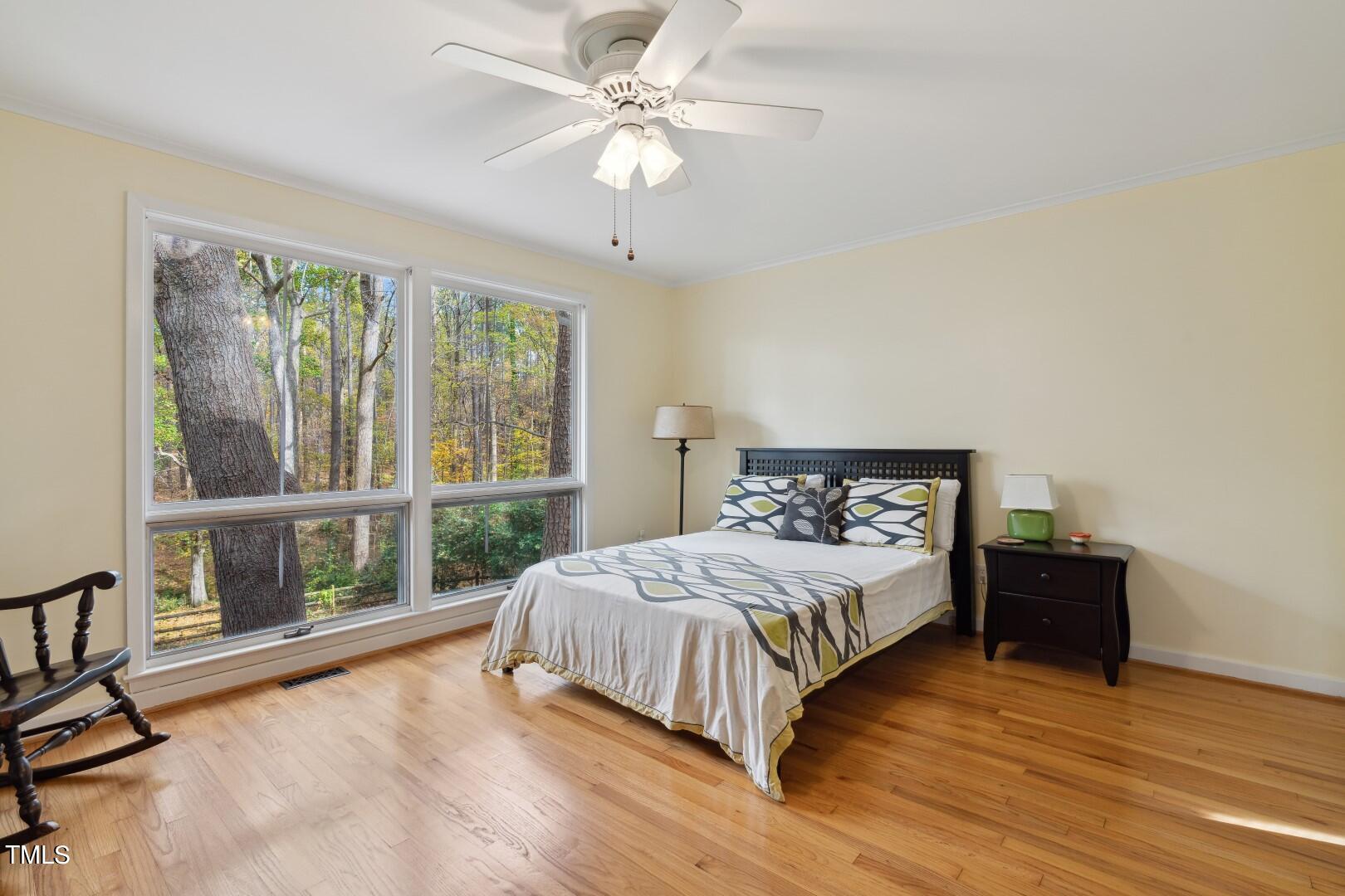3120 Tanager Street Raleigh, NC 27606 - Photo 25 of 70 a bedroom with a large bed and a large window