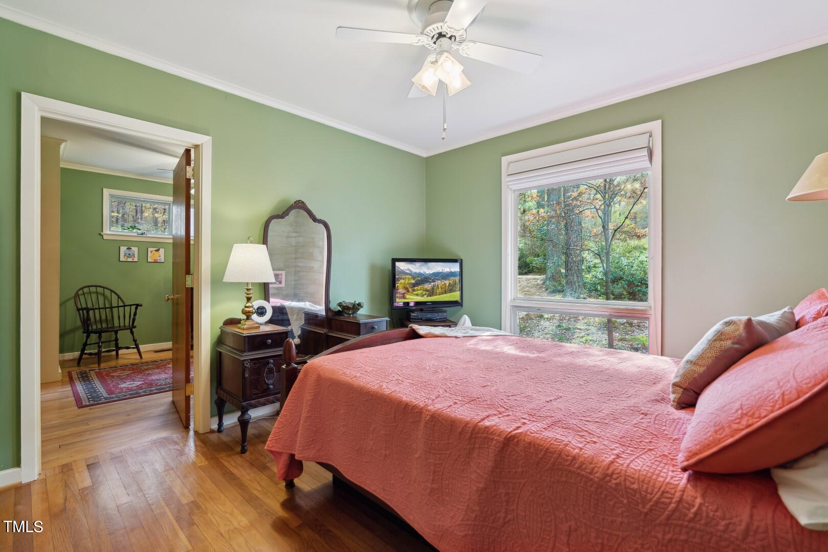 3120 Tanager Street Raleigh, NC 27606 - Photo 28 of 70 a bedroom with a bed large window with table and chair