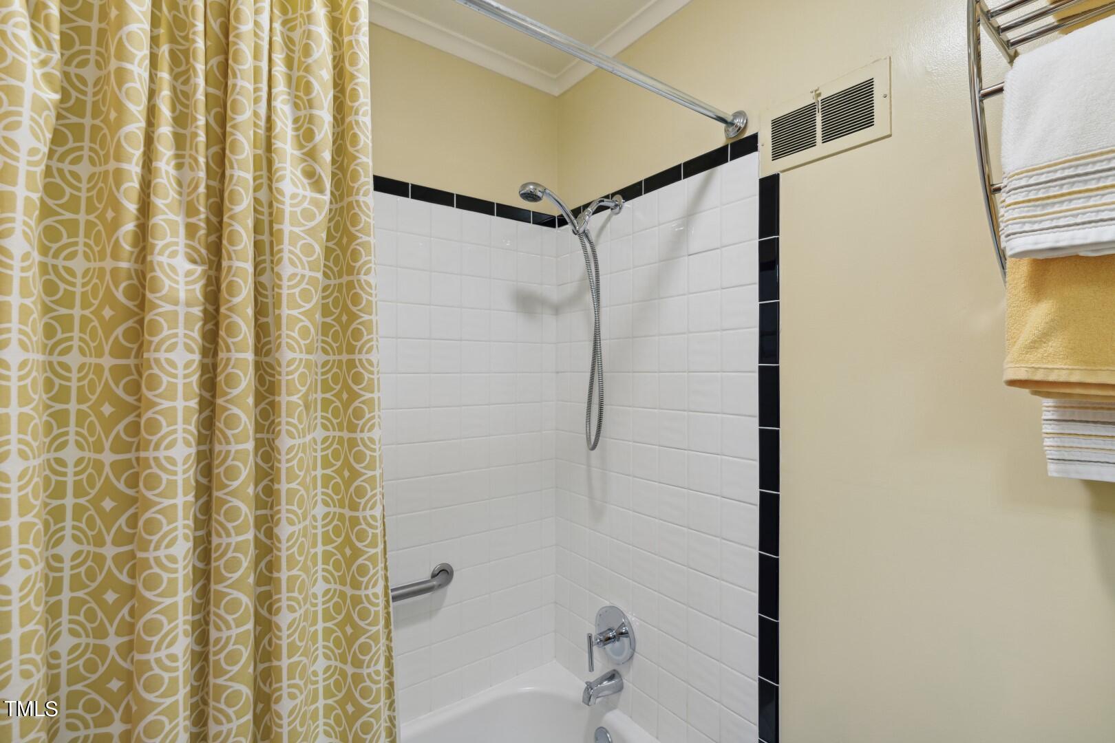 3120 Tanager Street Raleigh, NC 27606 - Photo 31 of 70 a bathroom with a shower and a shower curtain