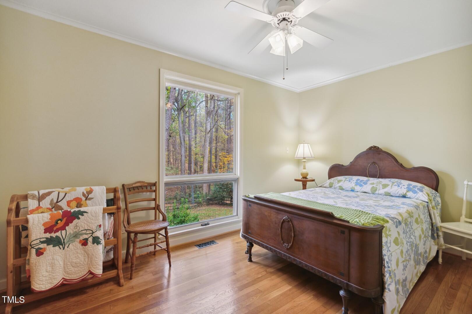 3120 Tanager Street Raleigh, NC 27606 - Photo 32 of 70 a bedroom with a bed and a chandelier