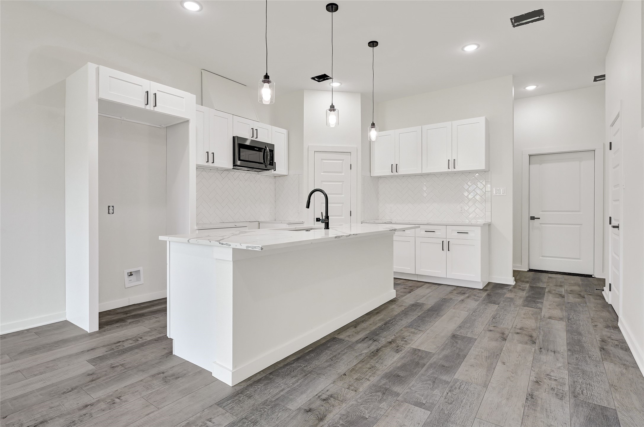 7922 Sealey Street Houston, TX 77088 - Photo 4 of 16 a large white kitchen with a sink a window and stainless steel appliances