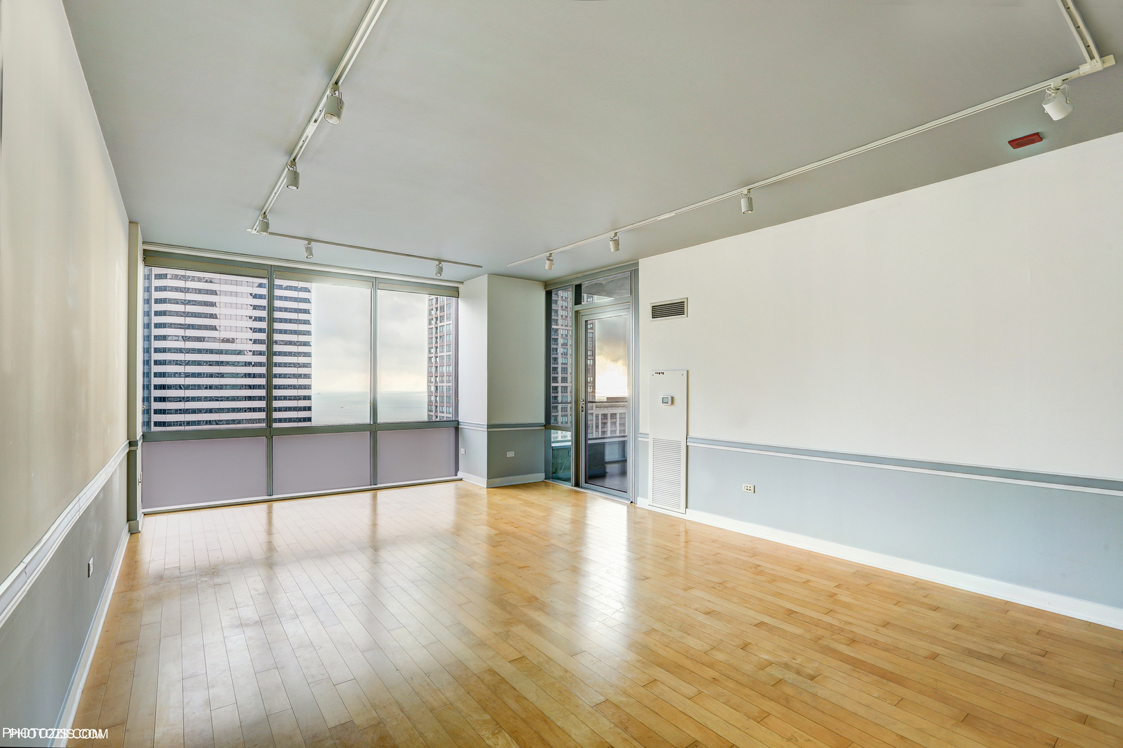8 East Randolph Street, Unit 2702 Chicago, IL 60601 - Photo 2 of 9 a view of empty room with wooden floor and fan