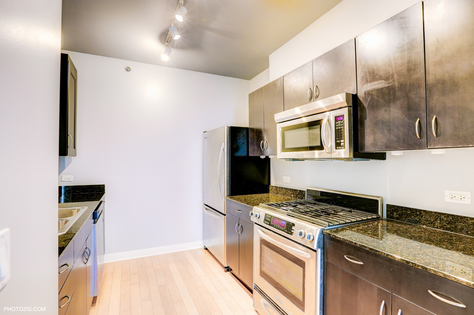 8 East Randolph Street, Unit 2702 Chicago, IL 60601 - Photo 3 of 9 a kitchen with stainless steel appliances granite countertop a stove and a refrigerator