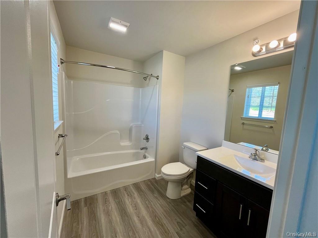 206 Golf Links Road, Unit 523 Middletown, NY 10940 - Photo 2 of 3 a bathroom with a sink a toilet and shower