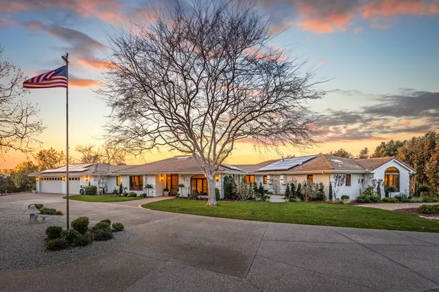 a front view of house with yard and green space