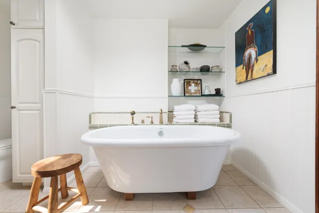 a white bath tub sitting next to a white sink