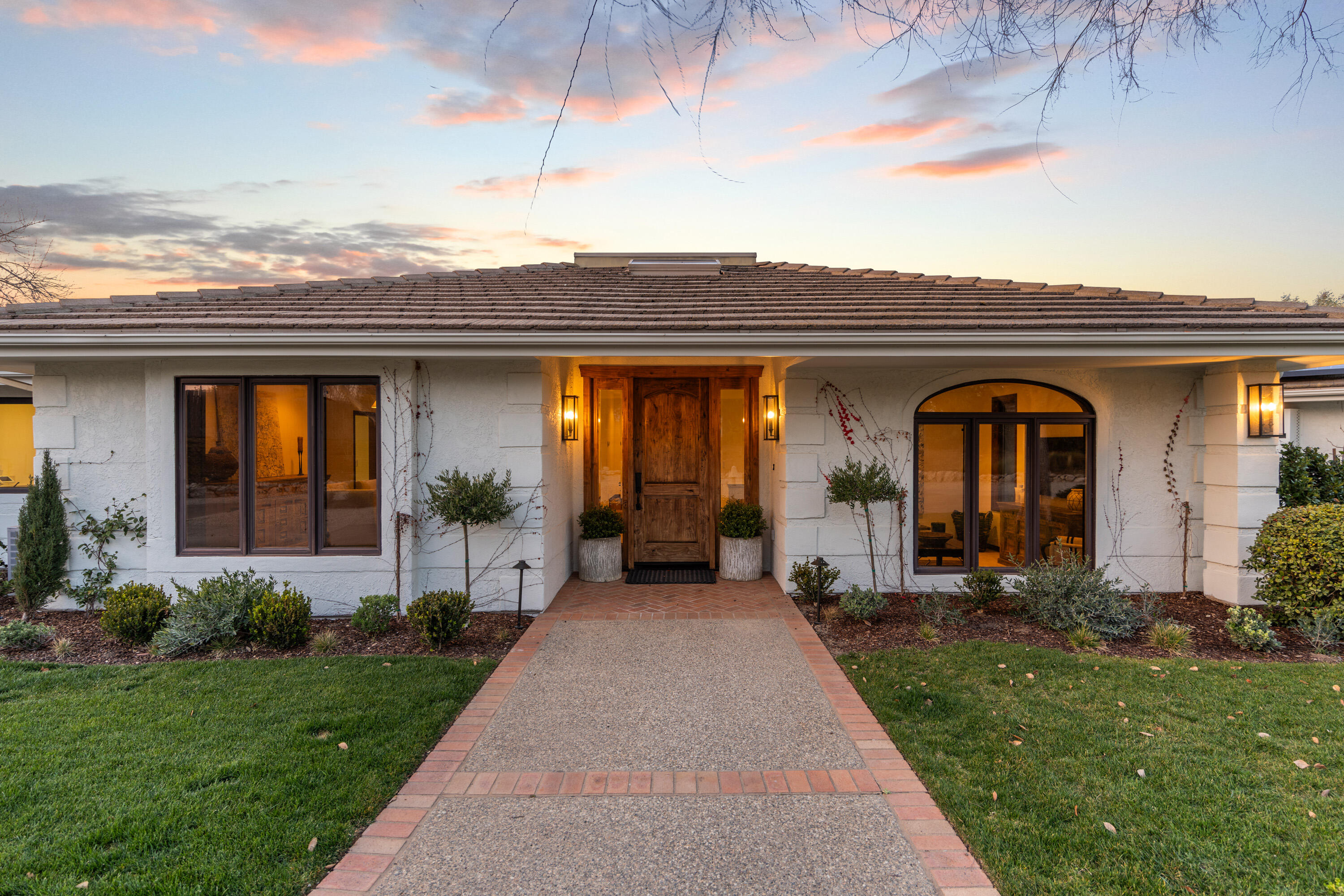 851 Adobe Creek Road Solvang, CA 93463 - Photo 5 of 46 a view of a house with many windows and a yard