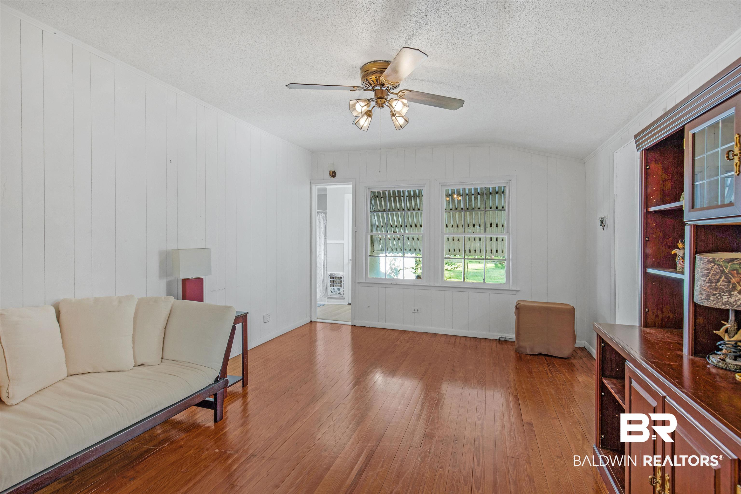 4306 Stein Street Mobile, AL 36608 - Photo 5 of 30 Living area featuring hardwood / wood-style flooring, a textured ceiling, lofted ceiling, and ceiling fan