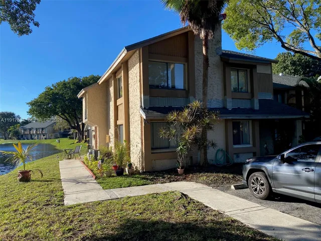 a view of a kitchen with furniture and stainless steel appliances