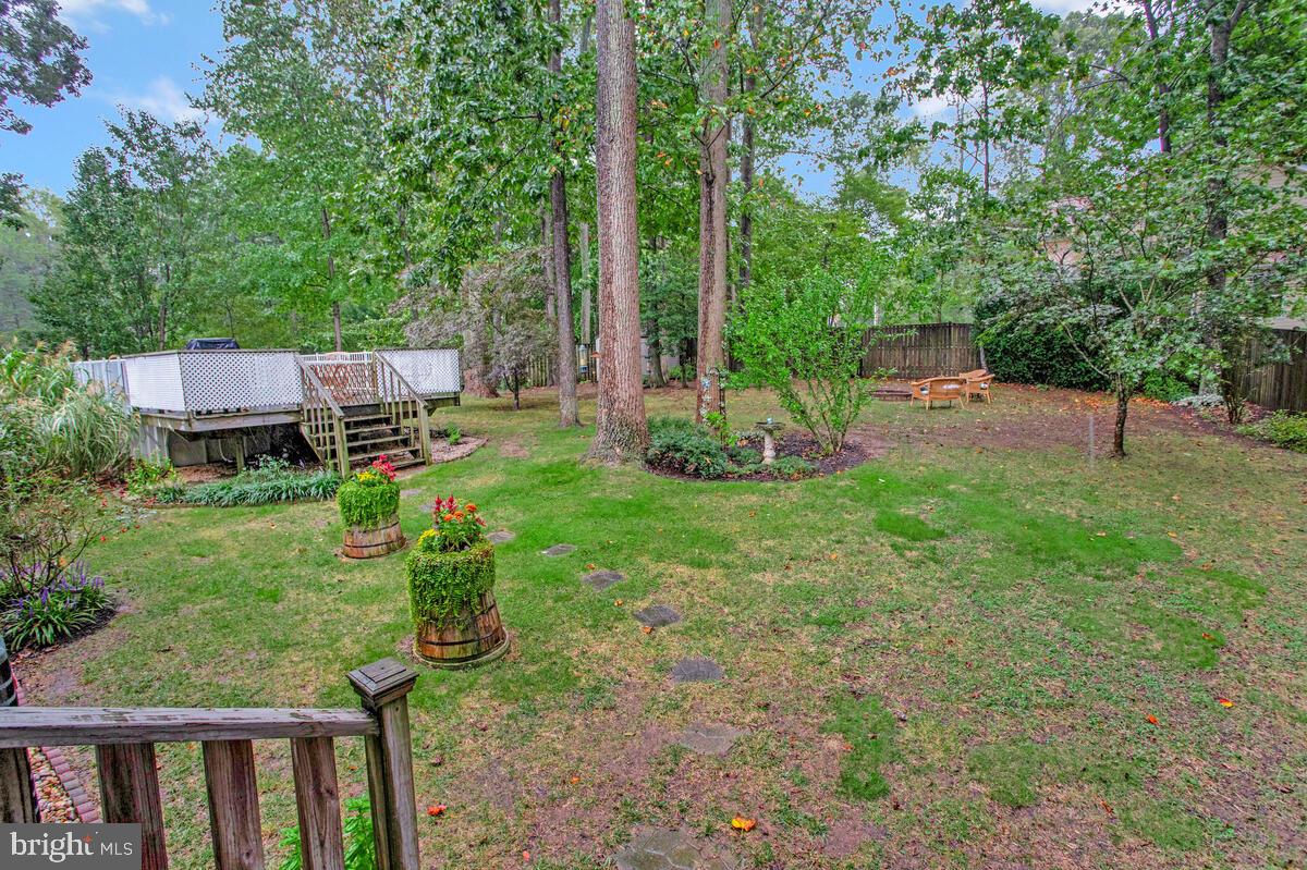 1805 Rudolph Lane Lusby, MD 20657 - Photo 33 of 43 a view of a backyard with table and chairs and wooden fence