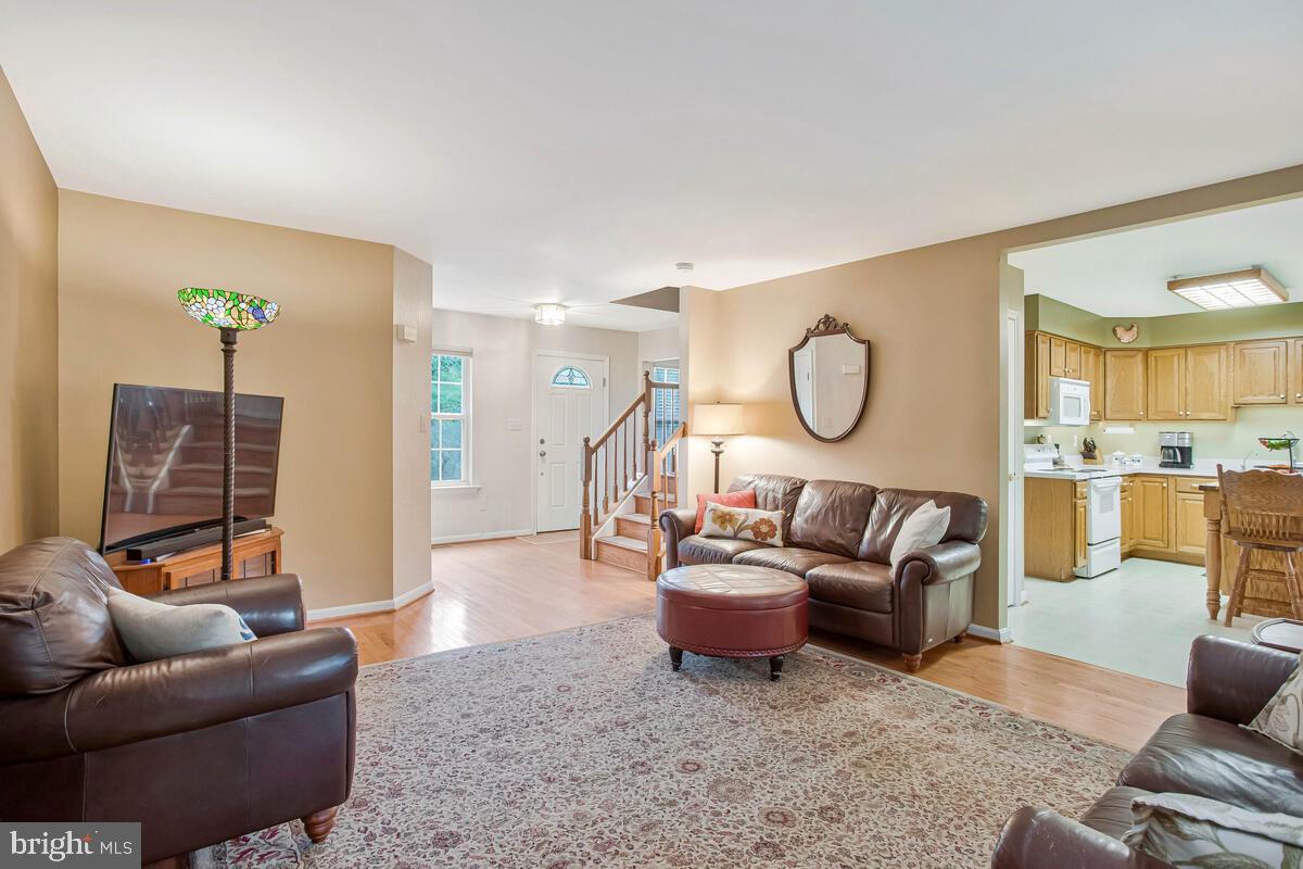 1805 Rudolph Lane Lusby, MD 20657 - Photo 5 of 43 a living room with furniture a rug and a chandelier