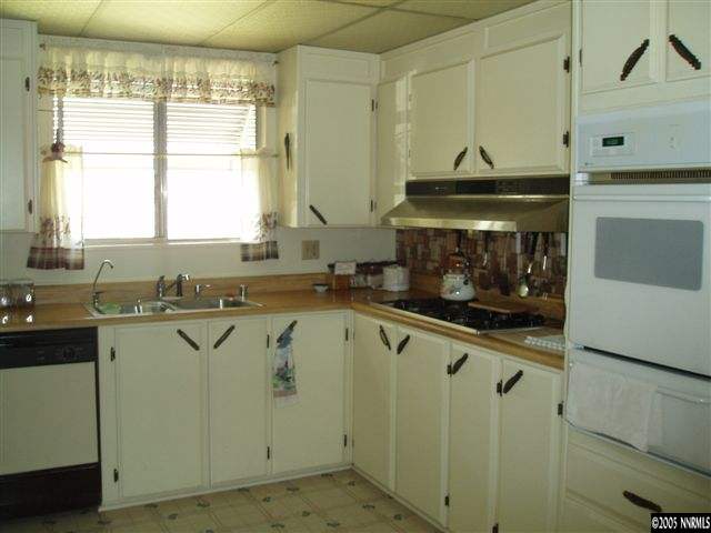 4768 Hiatt Loop Fallon, NV 89406 - Photo 4 of 9 a kitchen with stainless steel appliances granite countertop a stove a sink and a microwave