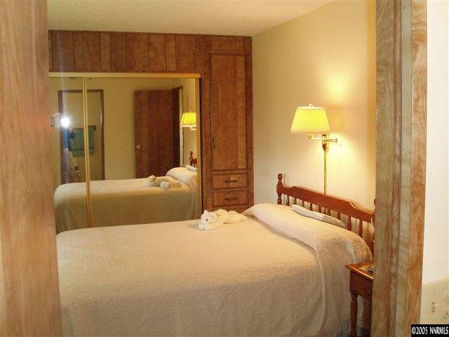 4768 Hiatt Loop Fallon, NV 89406 - Photo 6 of 9 a bedroom with a bed and a lamp