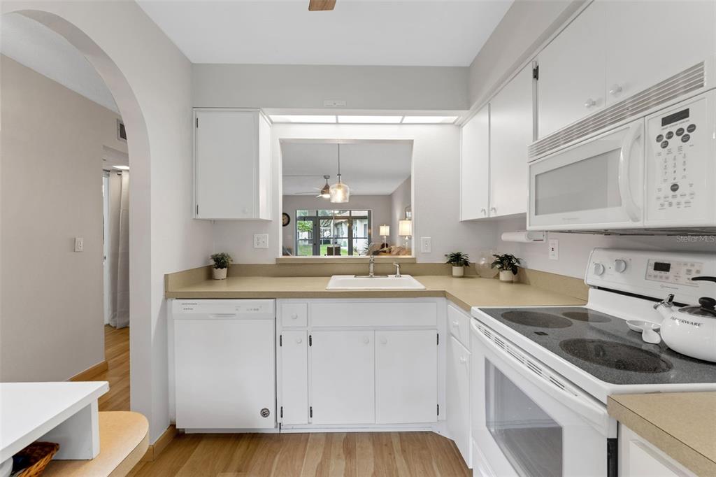 3140 Highlands Boulevard, Unit F Palm Harbor, FL 34684 - Photo 12 of 78 a kitchen with a sink stove and cabinets