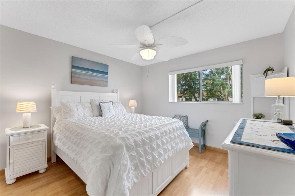 3140 Highlands Boulevard, Unit F Palm Harbor, FL 34684 - Photo 14 of 78 a bedroom with a bed and a table in it