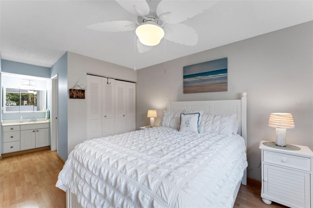 3140 Highlands Boulevard, Unit F Palm Harbor, FL 34684 - Photo 17 of 78 a bedroom with a bed and a chandelier