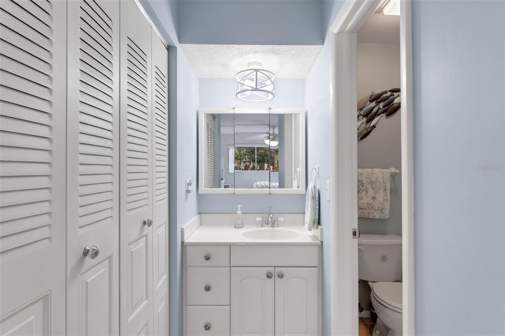 3140 Highlands Boulevard, Unit F Palm Harbor, FL 34684 - Photo 18 of 78 a bathroom with a sink a mirror and a window