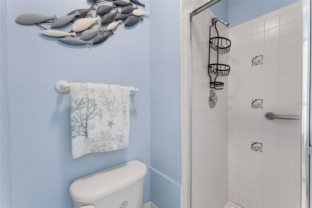 3140 Highlands Boulevard, Unit F Palm Harbor, FL 34684 - Photo 20 of 78 a white toilet sitting next to a shower curtain