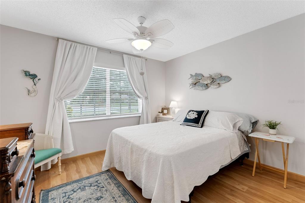 3140 Highlands Boulevard, Unit F Palm Harbor, FL 34684 - Photo 22 of 78 a bedroom with a bed and a window