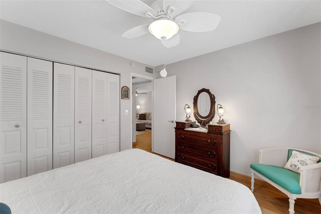 3140 Highlands Boulevard, Unit F Palm Harbor, FL 34684 - Photo 25 of 78 a bedroom with a bed and a chandelier