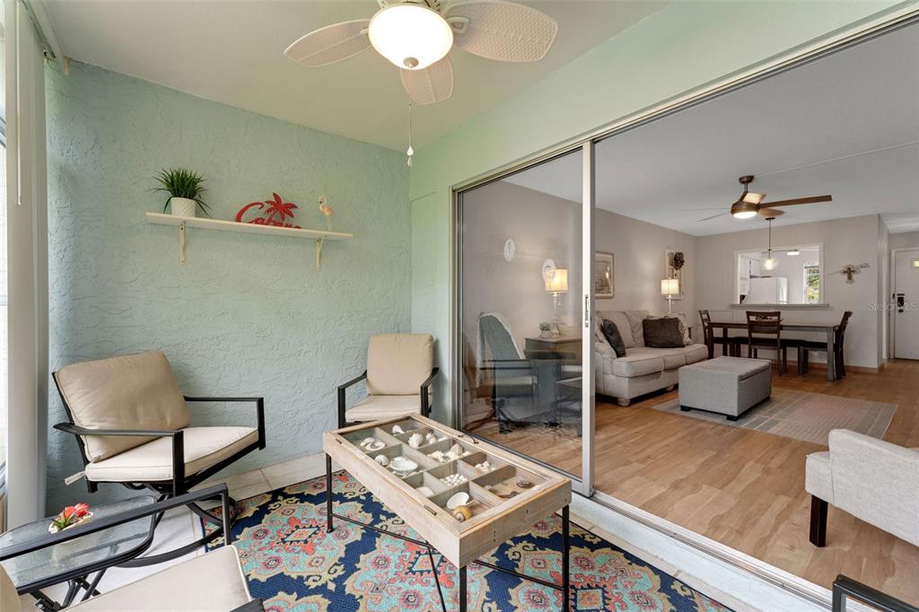 3140 Highlands Boulevard, Unit F Palm Harbor, FL 34684 - Photo 29 of 78 a living room with furniture and wooden floor