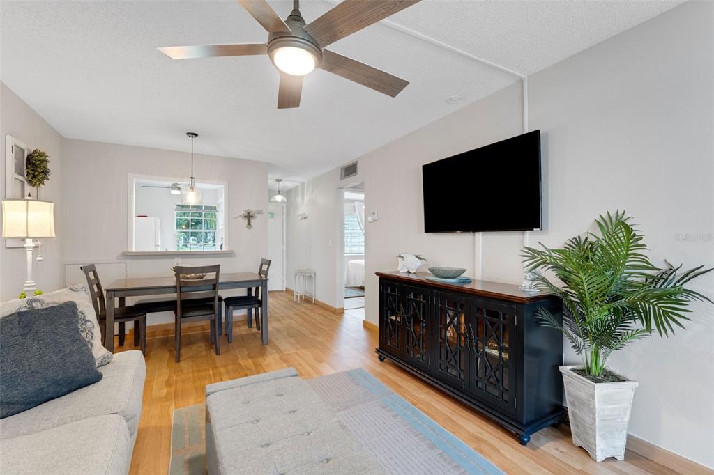 3140 Highlands Boulevard, Unit F Palm Harbor, FL 34684 - Photo 4 of 78 a living room with furniture and a flat screen tv