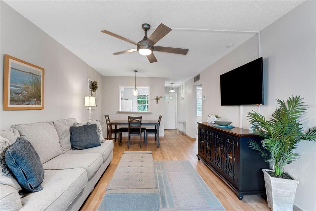 3140 Highlands Boulevard, Unit F Palm Harbor, FL 34684 - Photo 6 of 78 a living room with furniture and a flat screen tv