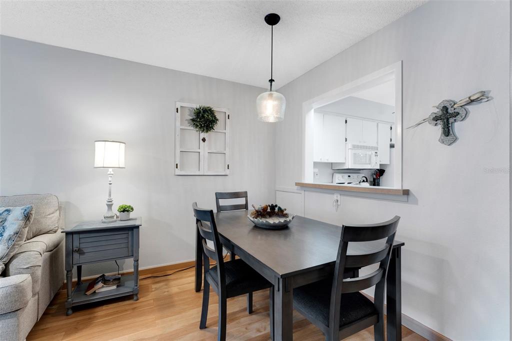3140 Highlands Boulevard, Unit F Palm Harbor, FL 34684 - Photo 7 of 78 a view of a dining room with furniture and wooden floor