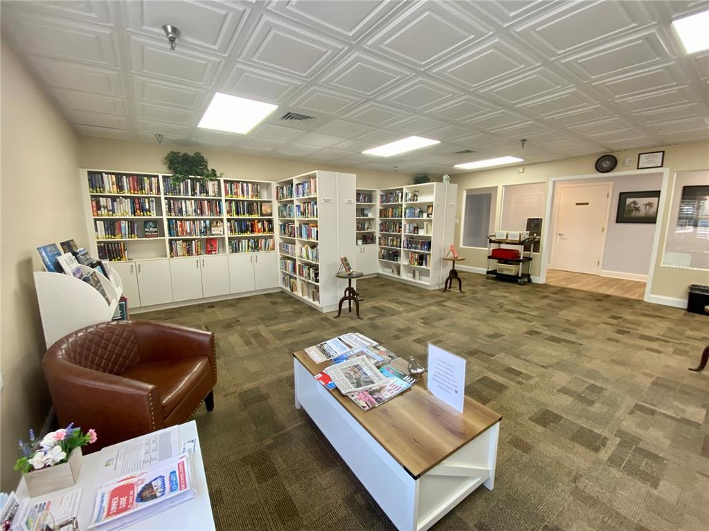 3140 Highlands Boulevard, Unit F Palm Harbor, FL 34684 - Photo 71 of 78 a living room with furniture and large windows