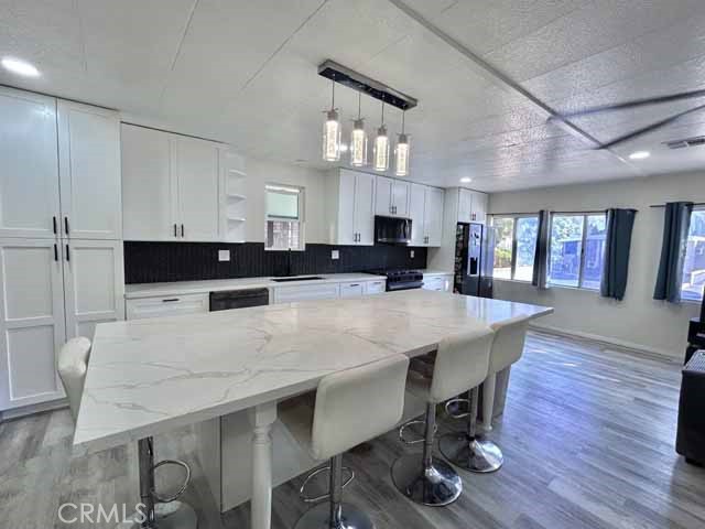 2751 Reche Canyon Road Moreno Valley, CA 92555 - Photo 12 of 20 a large kitchen with a table and chairs