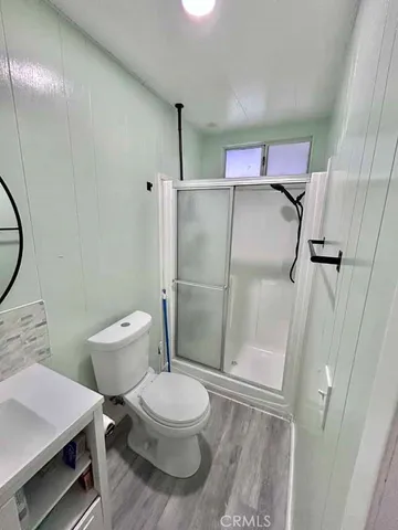 a bathroom with a toilet and a shower