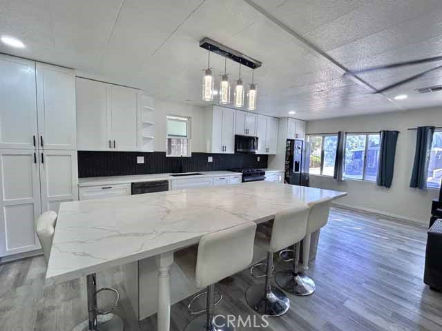 2751 Reche Canyon Road Moreno Valley, CA 92555 - Photo 6 of 20 a large kitchen with a table and chairs