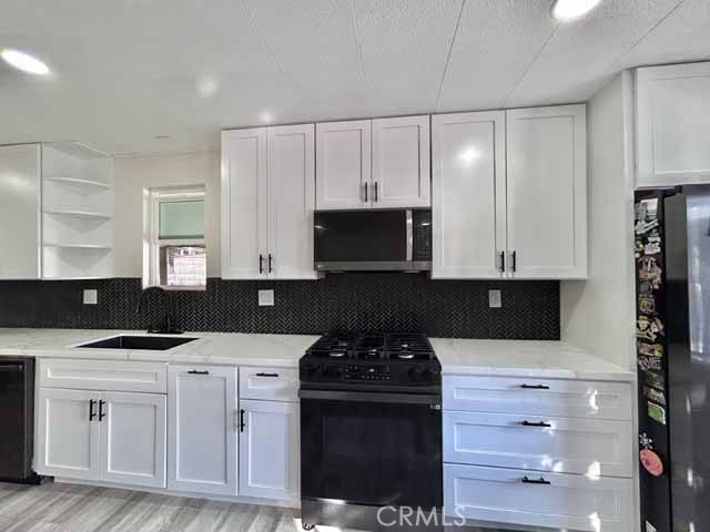 2751 Reche Canyon Road Moreno Valley, CA 92555 - Photo 7 of 20 a kitchen with a stove and a microwave