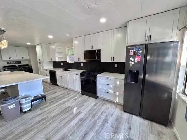 a kitchen with stainless steel appliances a refrigerator stove microwave and cabinets