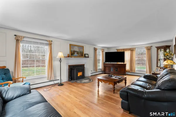 a living room with furniture a flat screen tv and a fireplace