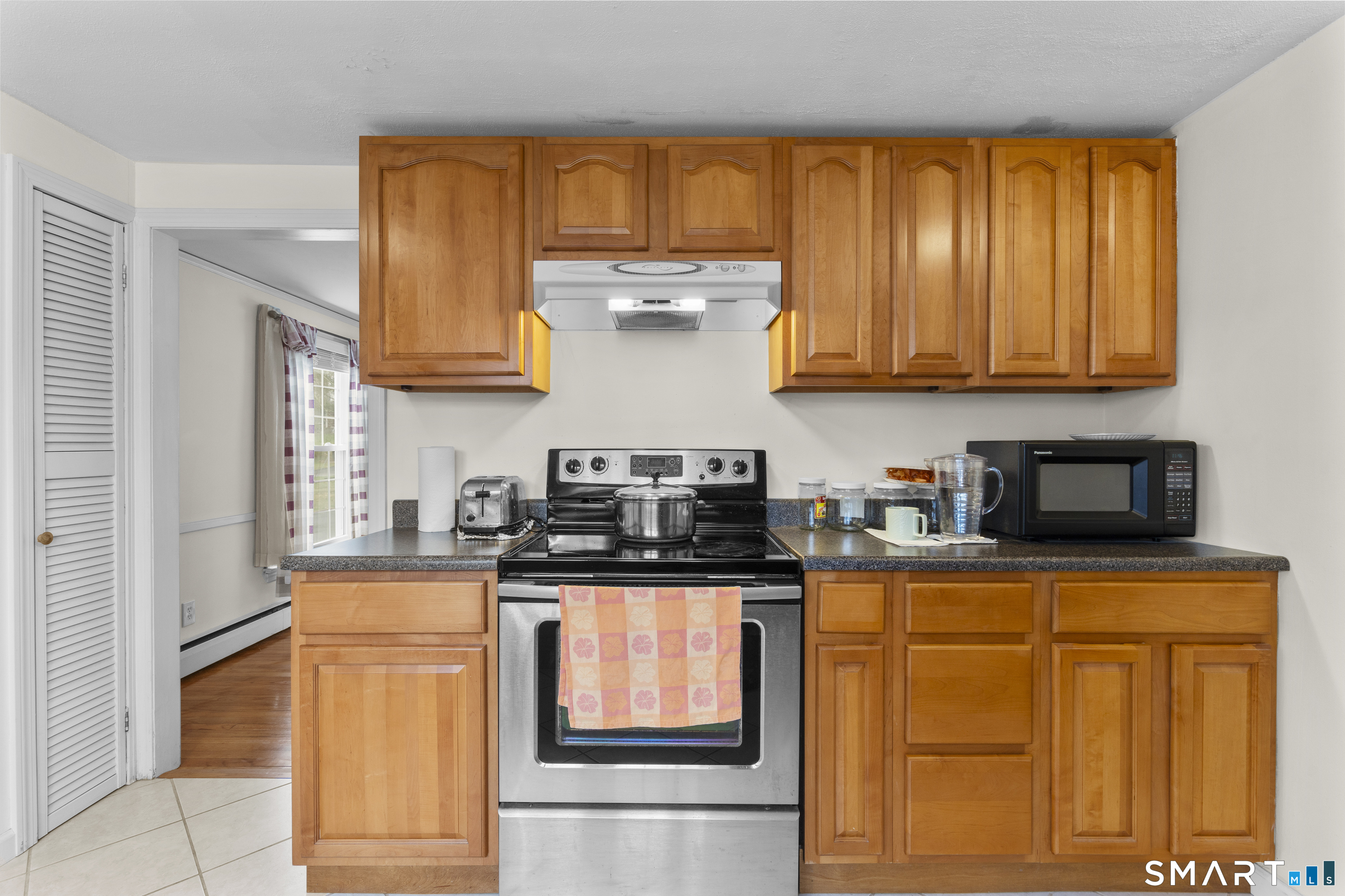 20 Inchcliffe Drive Ledyard, CT 06335 - Photo 4 of 40 a kitchen with granite countertop wooden cabinets and a window