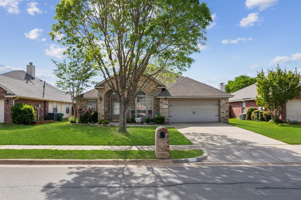 7216 Riverchase Trail Denton, TX 76210 - Photo 1 of 25 a front view of a house with a yard and garage