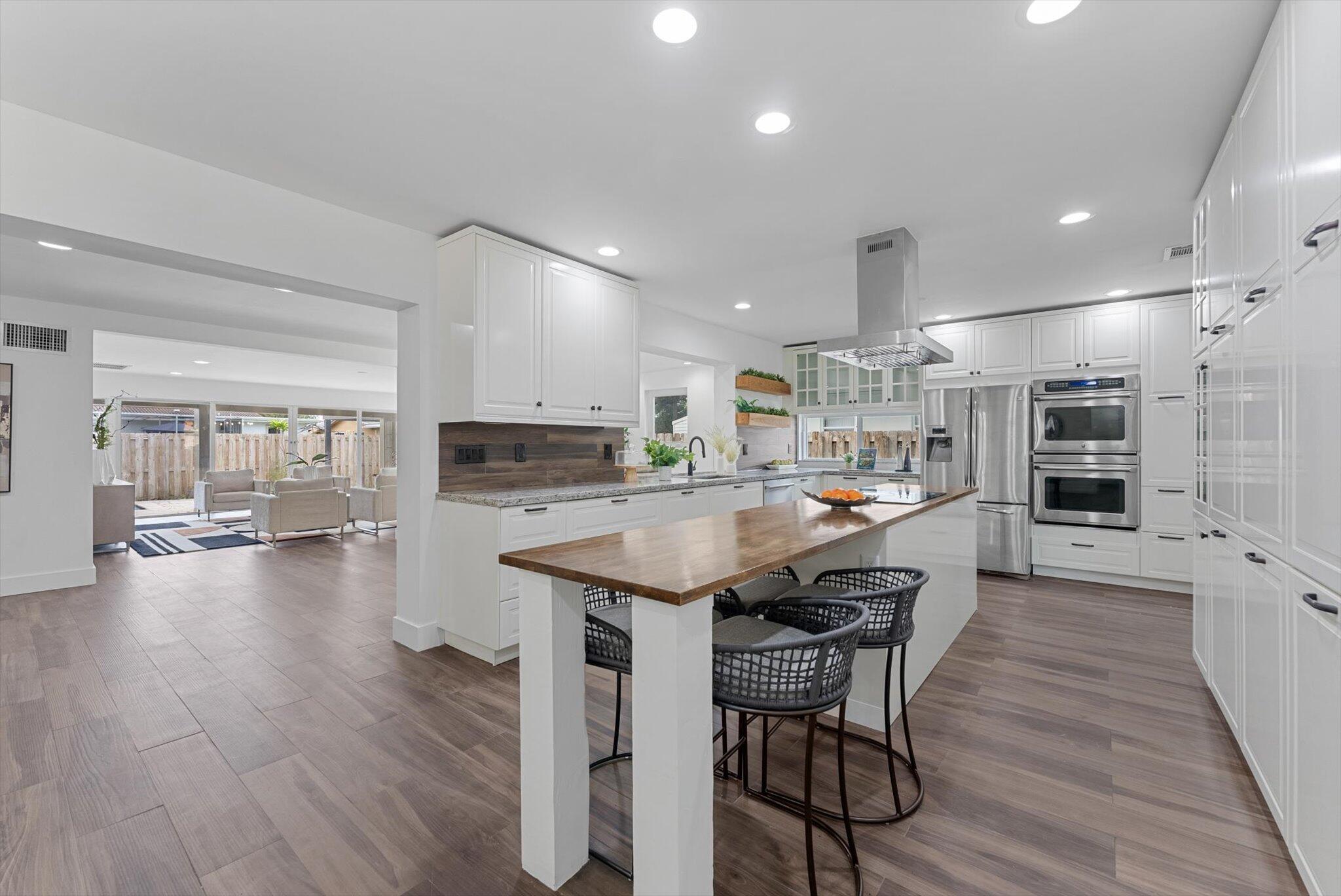 5412 Arthur Street Hollywood, FL 33021 - Photo 11 of 67 a kitchen with a table and chairs in it