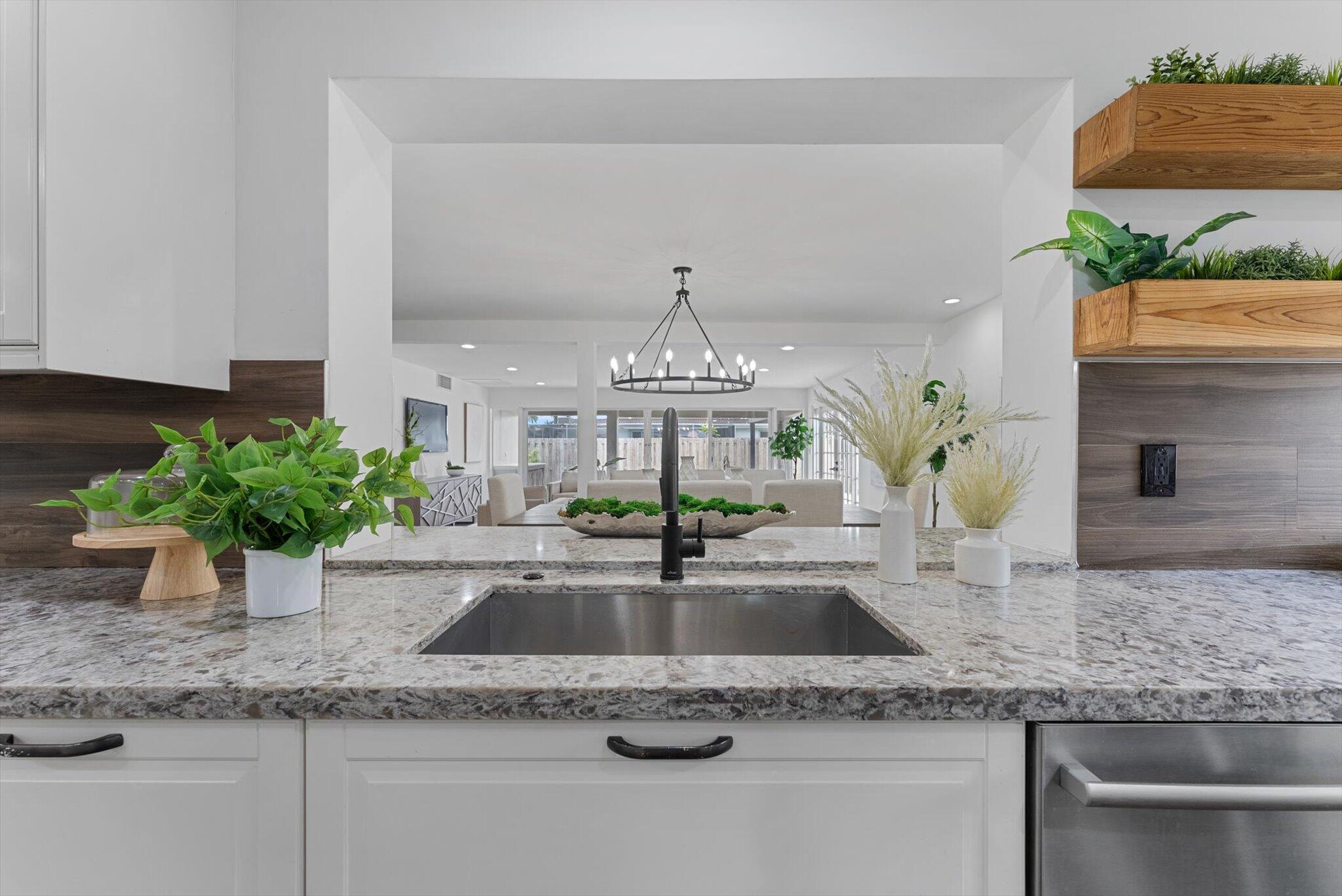 5412 Arthur Street Hollywood, FL 33021 - Photo 18 of 67 a kitchen with granite countertop a sink and a white stainless steel appliances