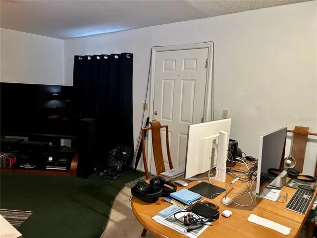 a room with gym equipment and a flat screen tv