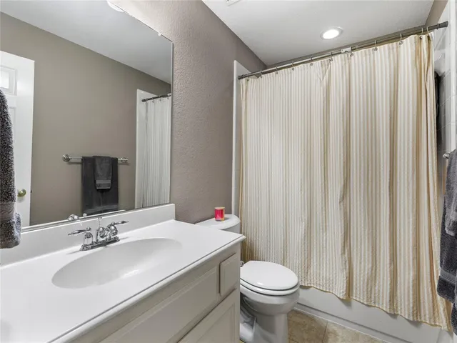 a bedroom with a bed a desk and chair