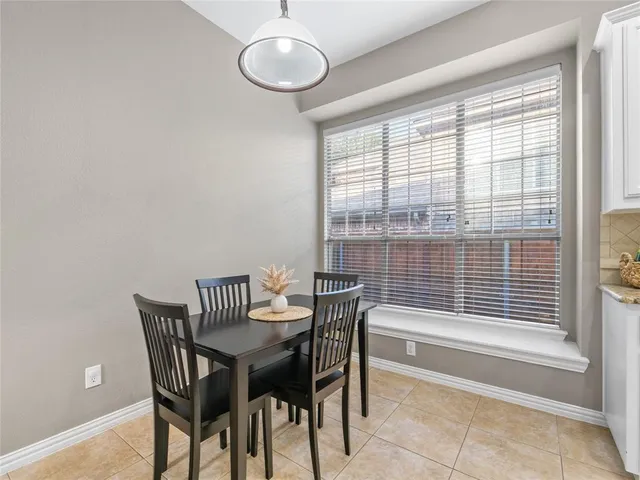 a view of a dining room with furniture and a large window