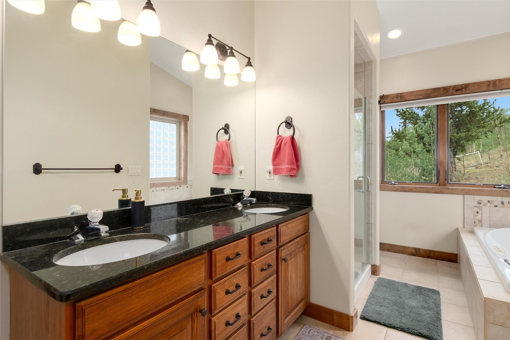 592 Ponderosa Road Fairplay, CO 80440 - Photo 25 of 45 a bathroom with a granite countertop sink and a mirror