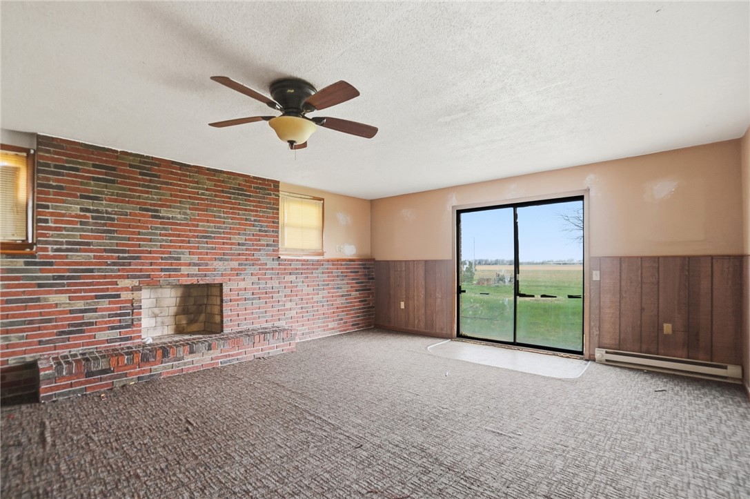 9750 Middlepoint Road Middle Point, OH 45863 - Photo 25 of 43 This family room features a brick fireplace and sliding doors that open to scenic views.
